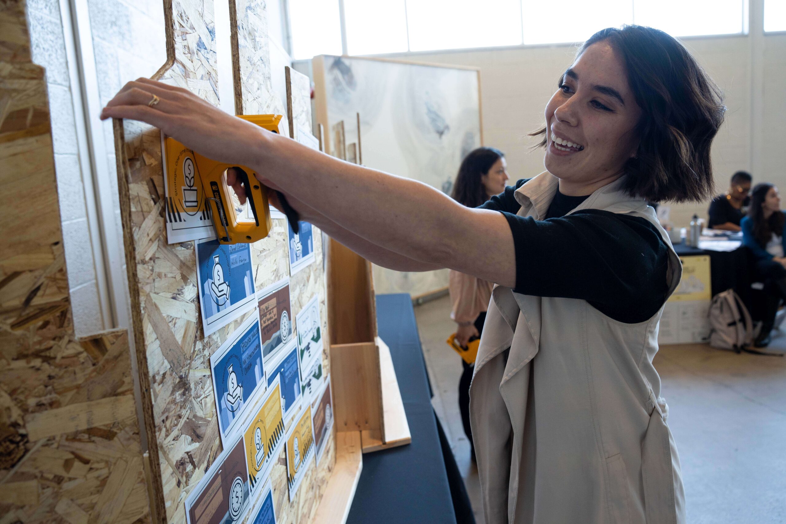 An individual pinning notes to a board during a brainstorm session